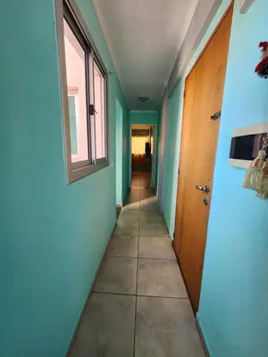 an empty hallway with a door and a window at General Paz KT I 7 in Cordoba