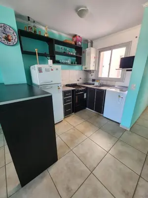 a kitchen with white appliances and blue walls at General Paz KT I 7 in Cordoba