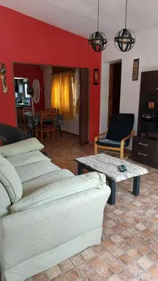 a living room with a couch and a coffee table at Casa a 800 mts de pleno centro - NO RECIBO GRUPO DE JOVENES in Villa Carlos Paz