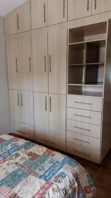 a bedroom with white cabinets and a bed at Casa a 800 mts de pleno centro - NO RECIBO GRUPO DE JOVENES in Villa Carlos Paz