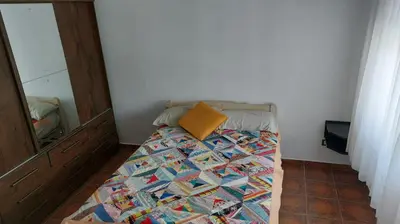 a bed with a pillow on it in a room at Casa a 800 mts de pleno centro - NO RECIBO GRUPO DE JOVENES in Villa Carlos Paz