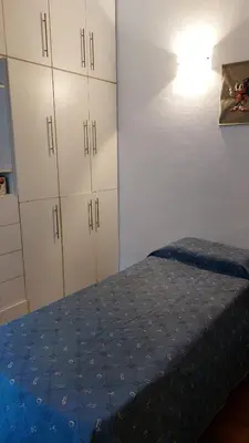 a bedroom with a bed and white cabinets at Casa a 800 mts de pleno centro - NO RECIBO GRUPO DE JOVENES in Villa Carlos Paz