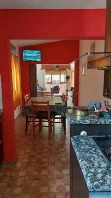 a kitchen and dining room with a table and chairs at Casa a 800 mts de pleno centro - NO RECIBO GRUPO DE JOVENES in Villa Carlos Paz