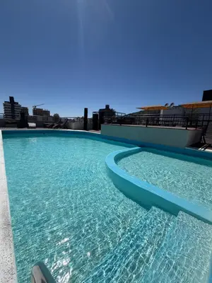 a swimming pool on the roof of a building at Depto Céntrico, Cochera, Pile, Terraza in Villa Carlos Paz