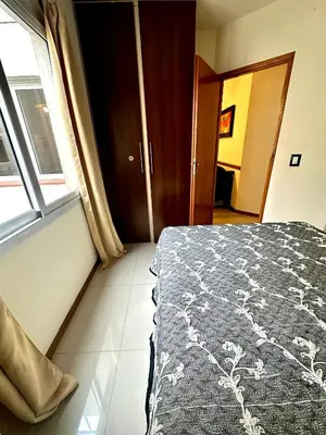a bedroom with a bed and a window at Depto Céntrico, Cochera, Pile, Terraza in Villa Carlos Paz
