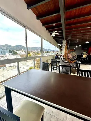 a ping pong table in a room with windows at Depto Céntrico, Cochera, Pile, Terraza in Villa Carlos Paz