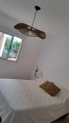 a bedroom with a bed with a ceiling fan at Vissia Vcp in Villa Carlos Paz