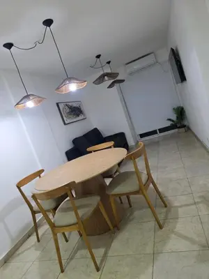 a table and chairs in a room with a couch at Vissia Vcp in Villa Carlos Paz