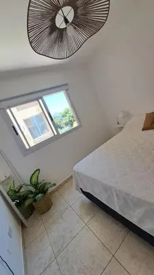 a bedroom with a bed and a ceiling fan at Vissia Vcp in Villa Carlos Paz