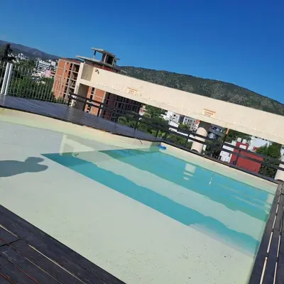 a large swimming pool in front of a building at Vissia Vcp in Villa Carlos Paz