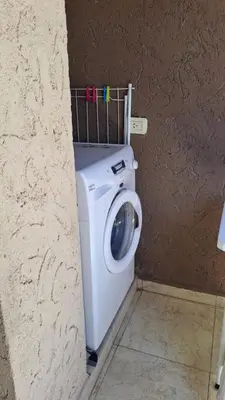 a bathroom with a washing machine in a wall at Vissia Vcp in Villa Carlos Paz