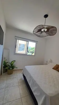 a bedroom with a large bed and a window at Vissia Vcp in Villa Carlos Paz