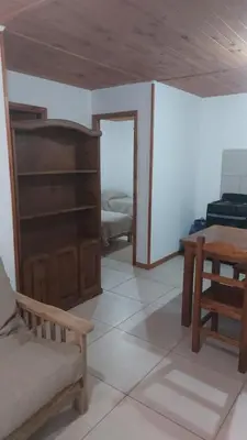 a living room with a couch and a table at Abuelo José Cabaña Serrana in Villa Yacanto