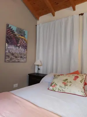 a bedroom with a bed with a pillow and a window at Ipomeas in Villa Rumipal