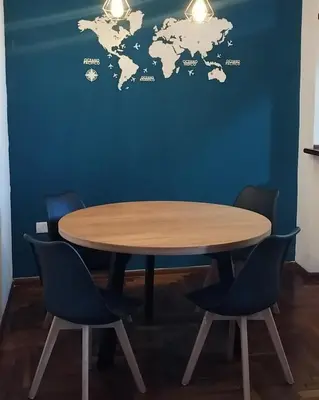 a table with chairs and a world map on a wall at Waru - Vista increíble y ubicación ideal in Cordoba