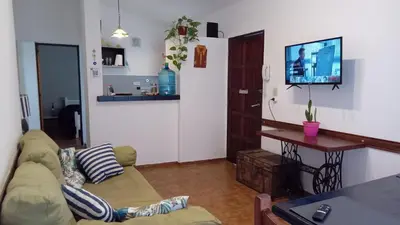 a living room with a couch and a table at Hospedaje La Dorita in Villa Carlos Paz