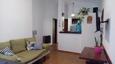 a living room with a couch and a table at Hospedaje La Dorita in Villa Carlos Paz