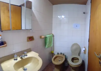 a bathroom with a sink and a toilet at Hospedaje La Dorita in Villa Carlos Paz