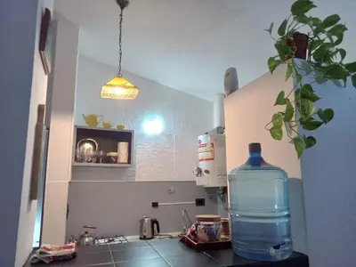 a bottle of water sitting on a counter in a kitchen at Hospedaje La Dorita in Villa Carlos Paz
