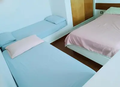 two beds sitting next to each other in a room at Departamento funcional in Villa Carlos Paz