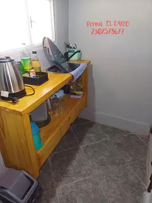 a room with a wooden desk with a coffee maker at El Carpo in Santa Rosa de Calamuchita