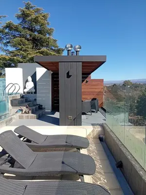 a group of chairs on the roof of a house at Departamento Brisas del Lago in Villa Carlos Paz