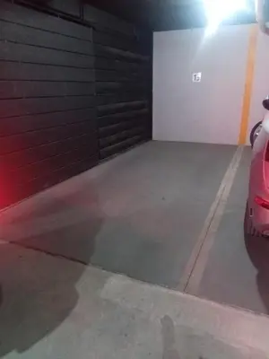 a garage with a car parked in it at Departamento Brisas del Lago in Villa Carlos Paz