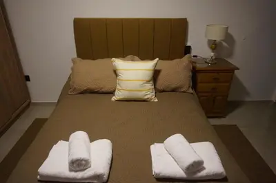 a bedroom with a bed with towels on it at Departamento Brisas del Lago in Villa Carlos Paz