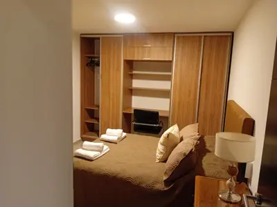 a bedroom with a bed and a desk with a lamp at Departamento Brisas del Lago in Villa Carlos Paz