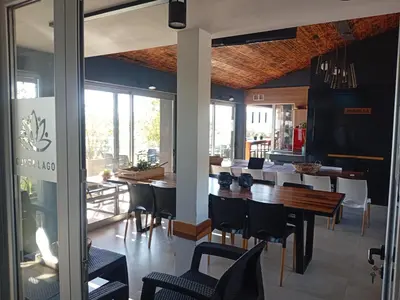 a dining room with a table and chairs at Departamento Brisas del Lago in Villa Carlos Paz