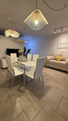 a dining table and chairs in a living room at Nueva Córdoba Ejecutivo in Cordoba