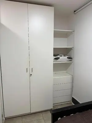 a white kitchen with white cabinets and a stove at Nueva Córdoba Ejecutivo in Cordoba