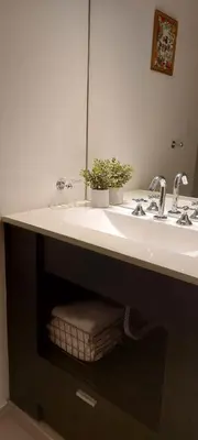 a bathroom with a sink with two potted plants on it at Village Tower - Hermoso departamento en excelente ubicación in Villa Carlos Paz