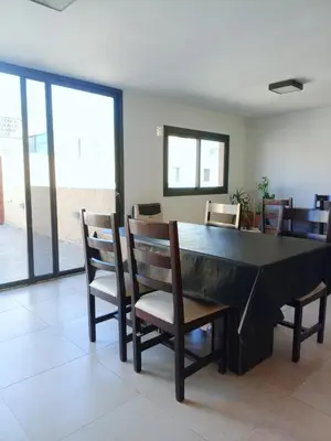 a dining room with a black table and chairs at Village Tower - Hermoso departamento en excelente ubicación in Villa Carlos Paz