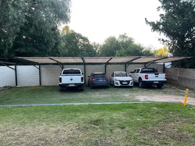 a group of cars parked in a parking lot at Olmos Suites in Mina Clavero