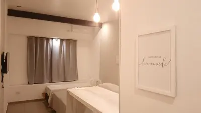 a white bathroom with a mirror and a sink at Olmos Suites in Mina Clavero