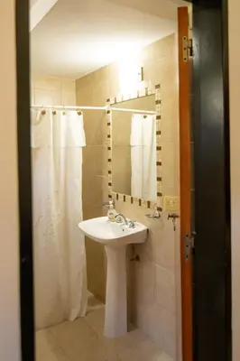 a bathroom with a sink and a shower at Los Robles in Villa Cura Brochero