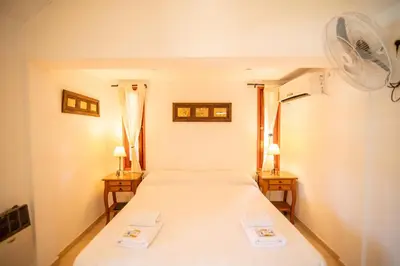 a bedroom with a bed and two night stands at Los Robles in Villa Cura Brochero