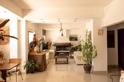 a living room with a couch and a fireplace at Los Robles in Villa Cura Brochero