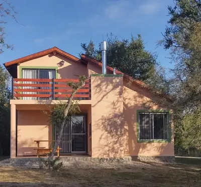 a house with a balcony on top of it at Cabañas La Ramadita in La Ramada