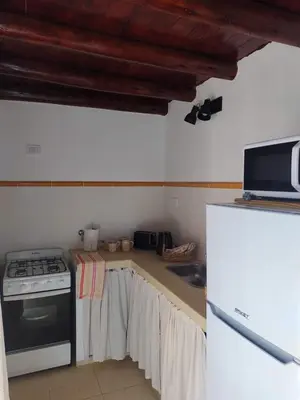 a kitchen with a stove and a sink at Cabañas La Ramadita in La Ramada