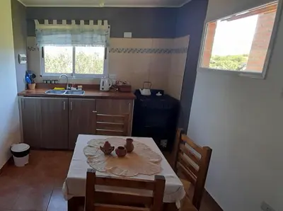 a kitchen with a table with two ducks on it at Cabañas Mini Tinkuy in Cortaderas