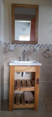 a bathroom with a sink and a mirror at Cabañas Mini Tinkuy in Cortaderas