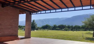 a view of a field with mountains in the background at Cabañas Mini Tinkuy in Cortaderas
