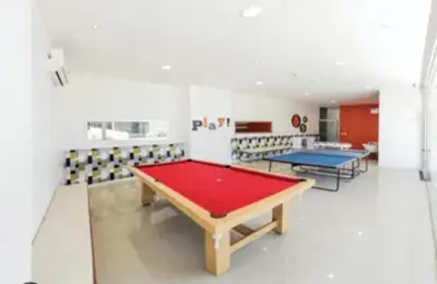 a room with a ping pong table and chairs at Departamento 1 dormitorio con pileta gimnasio y sala de juegos in Cordoba