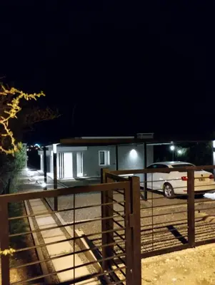 a car parked in front of a house at night at Tres Deseos in Villa Cura Brochero