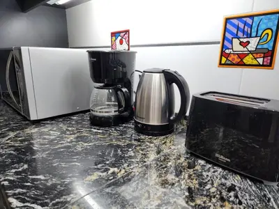 a kitchen counter with a coffee maker and a microwave at Beautiful and modern apartment in Alta Gracia in Alta Gracia