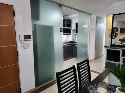 a dining room with a glass partition in a kitchen at Beautiful and modern apartment in Alta Gracia in Alta Gracia