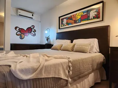 a bedroom with a bed and a painting on the wall at Beautiful and modern apartment in Alta Gracia in Alta Gracia