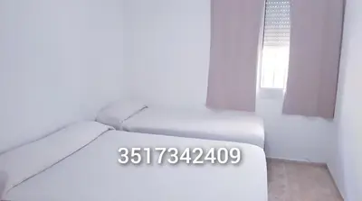 a white room with a bed and a window at Alojamiento en Carlos Paz in Villa Carlos Paz